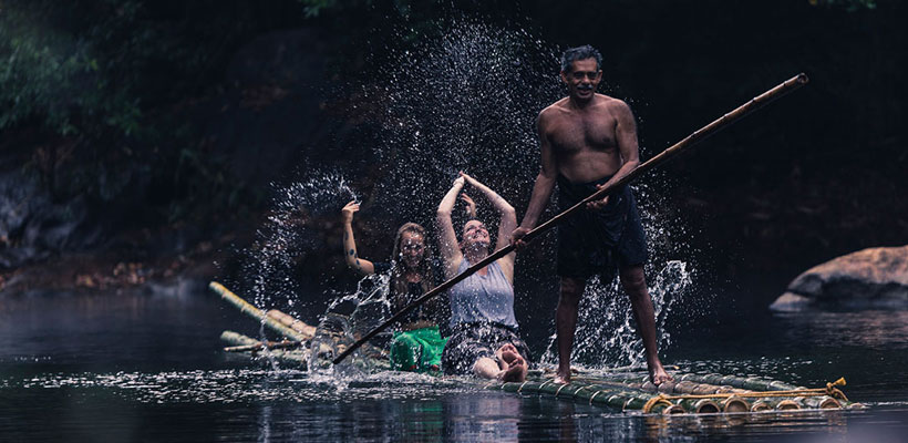 Tourists enjoying the bamboo rafting ride in the backwaters of Kerala